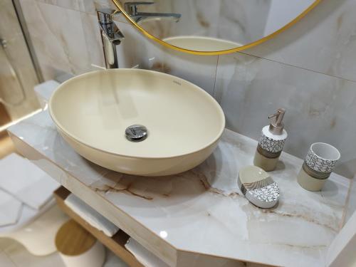 a white sink on a counter in a bathroom at AEGEAN SUITES in Keramotí