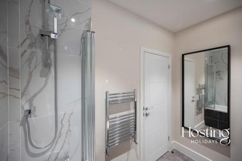 a bathroom with a shower and a glass door at The Oars Apartment - Marlow - Parking Included in Marlow