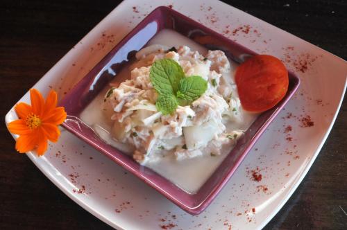 a plate with a dish of food on a table at Mango Island Lodges in Saint Joseph