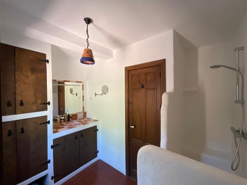 a bathroom with a tub and a sink and a mirror at Casa Pura Vida - Malaga - Andalusië in Colmenar
