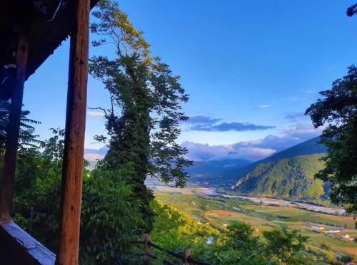 a view of a valley from a hill with trees at Wine Space in Ambrolauri