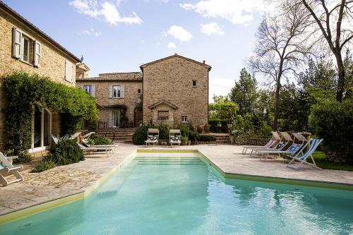 a swimming pool in front of a house at Castello di Granarola - Dimora storica, Suites e Appartamenti in Gradara