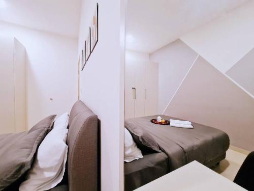 a room with two beds and a table in it at New! 4-6pax Mount Austin High Condo in Johor Bahru in Johor Bahru