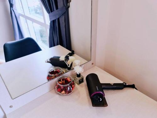 a table with a mirror and a hair dryer on it at New! 4-6pax Mount Austin High Condo in Johor Bahru in Johor Bahru