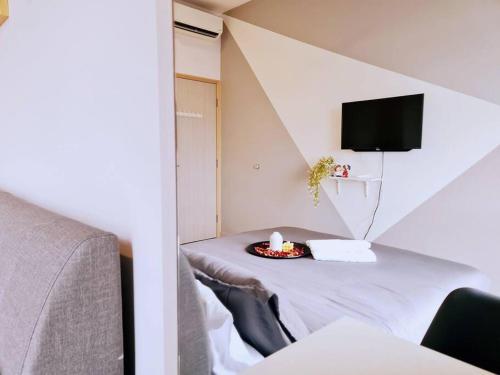 a room with a table with a bed and a tv at New! 4-6pax Mount Austin High Condo in Johor Bahru in Johor Bahru