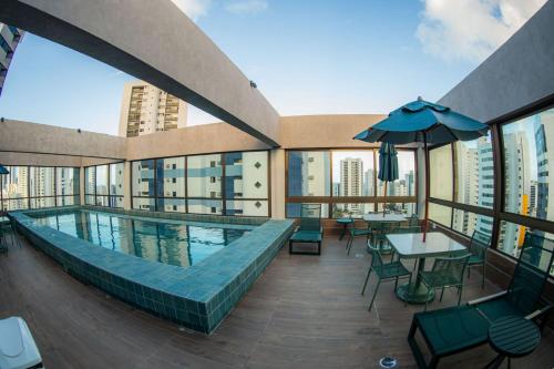 a swimming pool on the roof of a building at BOA VIAGEM - FLAT ROOFTOP ALTO PADRÃO in Recife
