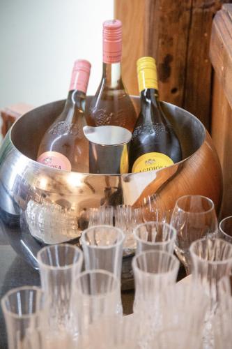 a bucket of wine bottles and wine glasses at Sieben Zimmer am See in Prien am Chiemsee