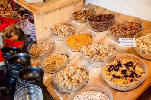a table topped with bowls of different types of food at Sieben Zimmer am See in Prien am Chiemsee
