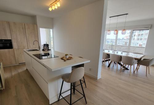 a kitchen with a island in the middle of a room at Kustverhuur, Appartement aan Zee, Port Scaldis 09-022 in Breskens