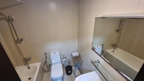 a bathroom with a sink and a toilet and a mirror at Full Sea view studio in Ras al Khaimah
