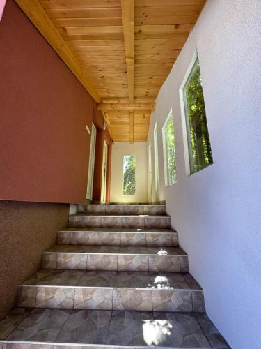 a staircase in a house with a wooden ceiling at Apartman Ejna in Sarajevo