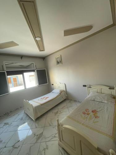 מיטה או מיטות בחדר ב-Driouch 2 slaapkamers