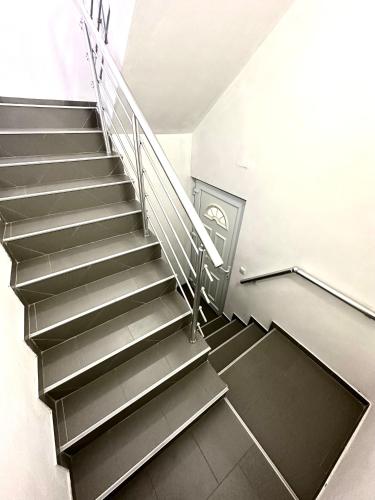 a spiral staircase in a building with a stair case at Apartman Ejna in Sarajevo