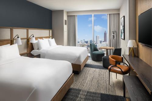 a hotel room with two beds and a large window at Signia By Hilton Atlanta Georgia World Congress Center in Atlanta