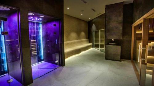 a hallway with purple lights in a building at Woodside Apartment in Kopaonik