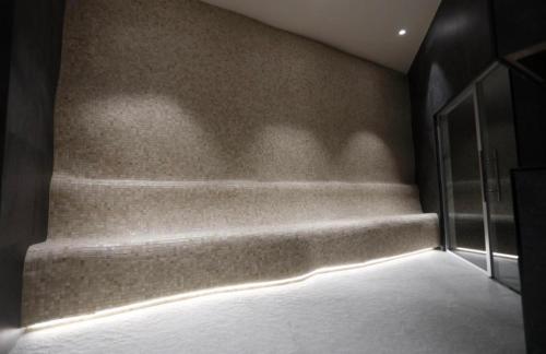 a room with a staircase with a light on the wall at Woodside Apartment in Kopaonik