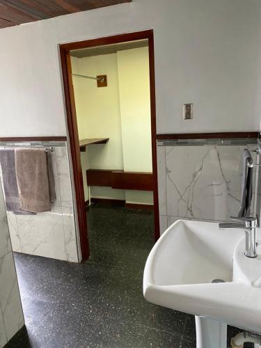 a bathroom with a sink and a mirror at Tranquility Estate in Kingston