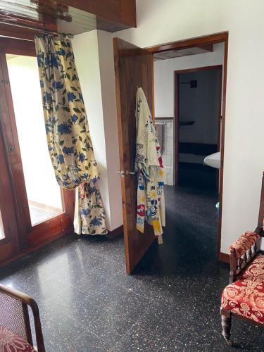 a room with a door with curtains and a surfboard at Tranquility Estate in Kingston