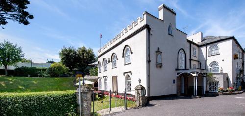 a white church with a fence in front of it at Royal Glen Hotel in Sidmouth