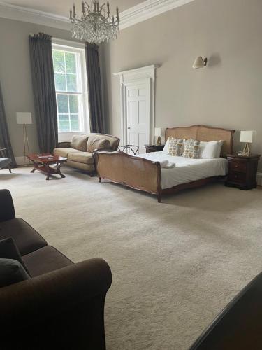 a large bedroom with a bed and a couch at Private Guest Suite in Georgian Townhouse in City Centre in Edinburgh