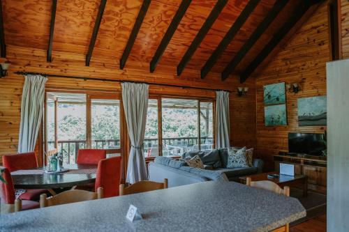 a living room with a couch and a table at Thunzi Bush Lodge in Beachview