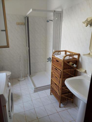 a bathroom with a shower and a toilet and a sink at Rocca tagliata Marsala in Marsala