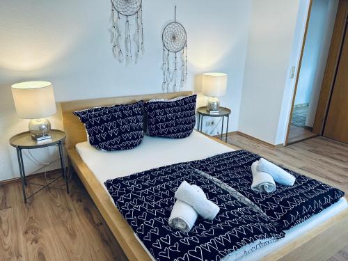 a bedroom with a bed with blue and white sheets and pillows at Lidia Apartment in Celle