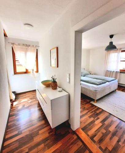 a bedroom with a bed and a wooden floor at Ferienwohnung Sankt Martin 225 N.N. in Sankt Martin
