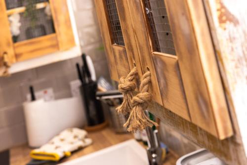 a kitchen with a sink and a wooden cabinet at James' Place at The Park in Merthyr Tydfil
