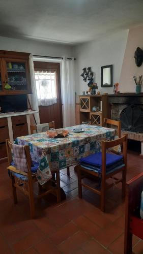 a dining room with a table and chairs and a fireplace at Artenatura BeB in Terranuova Bracciolini