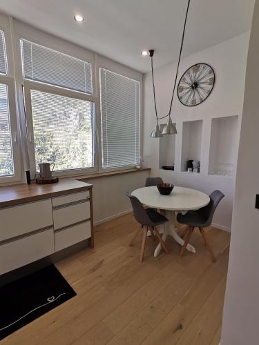 a kitchen and dining room with a table and chairs at KELEIA NEW VILLAGE in Celje