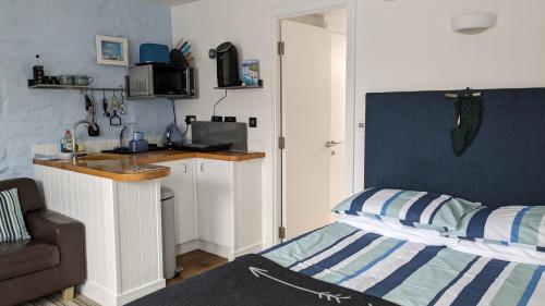 a small bedroom with a sink and a bed at Studio 2 in Newquay