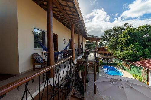 a balcony of a house with a swimming pool at Pousada Pé na Estrada in Arraial d'Ajuda