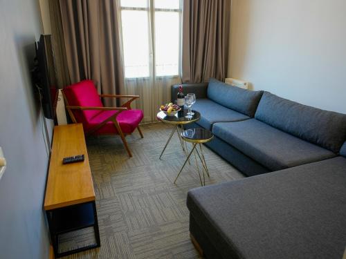 - un salon avec un canapé bleu et une table dans l'établissement Cihangir Residences, à Istanbul