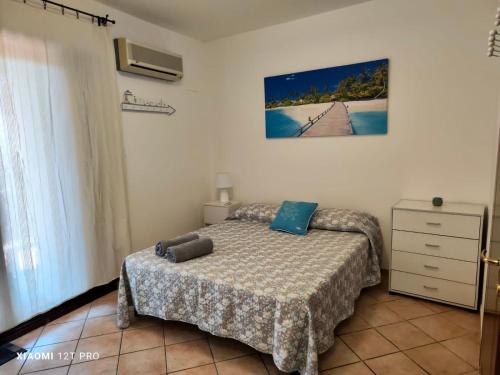 a bedroom with a bed and a dresser at Kary Studio Apartment in Olbia