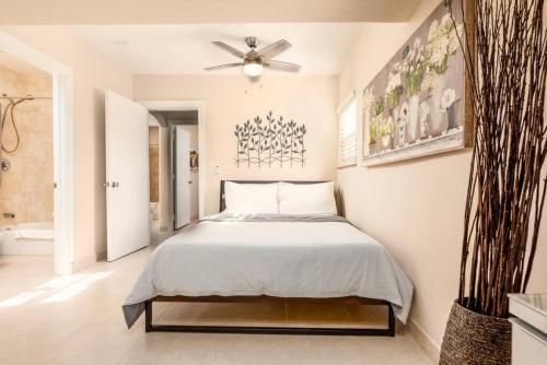 a bedroom with a bed and a ceiling fan at Ocean Flats 1 - Lauderdale-by-the-Sea in Fort Lauderdale