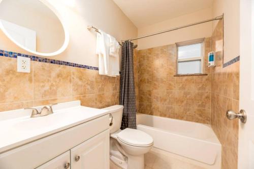a bathroom with a sink and a toilet and a bath tub at Ocean Flats 1 - Lauderdale-by-the-Sea in Fort Lauderdale
