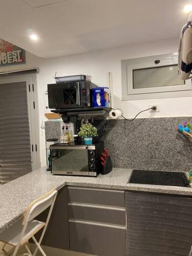 a kitchen with a counter top with a microwave at Gouna Pool view with rooftop living & BBQ grill in Hurghada
