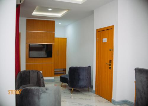 a waiting room with two chairs and a door at Dominance Events and Suites in Ibadan