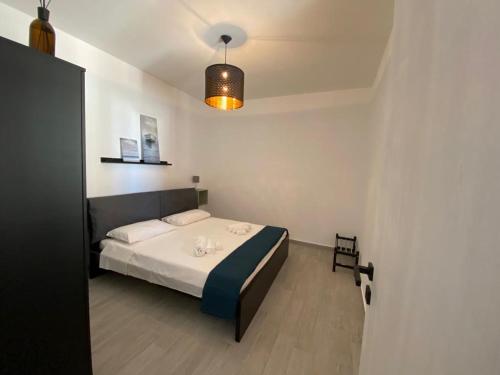 a bedroom with a bed and a light on the ceiling at Casa di Giu' - favignana in Favignana