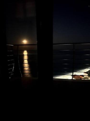 a view of the ocean from a balcony at night at The Yacht House in Agios Ioannis Pelio