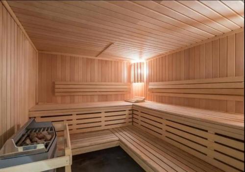 a large wooden sauna with wooden floors and ceilings at Appartement pied pistes à Val thorens in Val Thorens