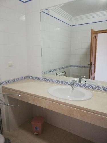 a bathroom with a sink and a mirror at Villa V2 V in Olhos de Água