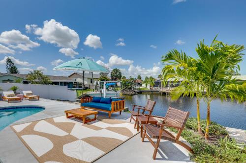 a patio with chairs and a swimming pool with a fountain at Luxury Gem with Private Pool and Dock in Apollo Beach in Apollo Beach