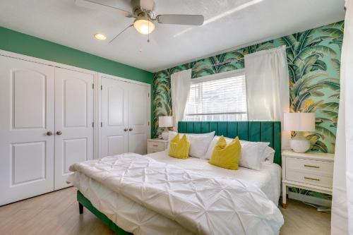 a bedroom with a large white bed with yellow pillows at Luxury Gem with Private Pool and Dock in Apollo Beach in Apollo Beach