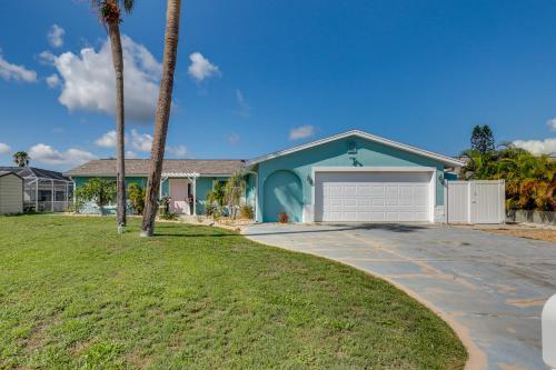 a house with a driveway and a palm tree at Luxury Gem with Private Pool and Dock in Apollo Beach in Apollo Beach