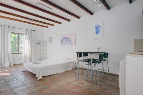 a white room with a bed and a table at Casa Yolanda in Marbella