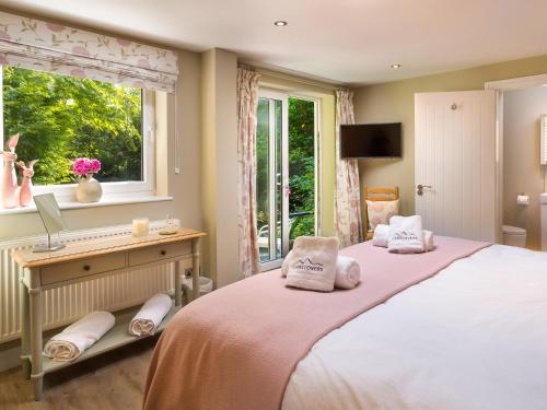 a bedroom with a large bed and a window at Mere View in Windermere