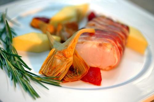 a plate of food with a piece of meat and vegetables at Gästehaus Alt-Weimar in Weimar