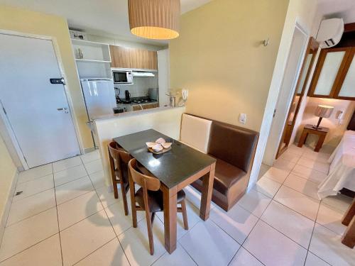 a kitchen and dining room with a table and chairs at Resort VG SUN por Be My Guest! in Caucaia